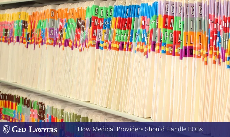 Rows of color-coded file folders illustrating EOB handling and records management for medical providers